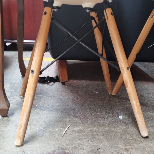 649 - Pair of Mid-Century Modern style plastic shell chairs with wooden legs. One chair is white, and the ... 