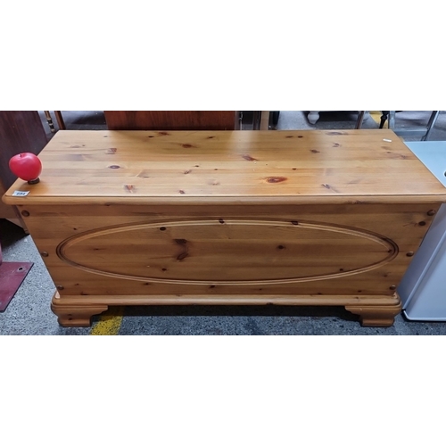 654 - Solid pine blanket chest with hinged lid and carved oval detailing. Measures approximately 40 inches... 