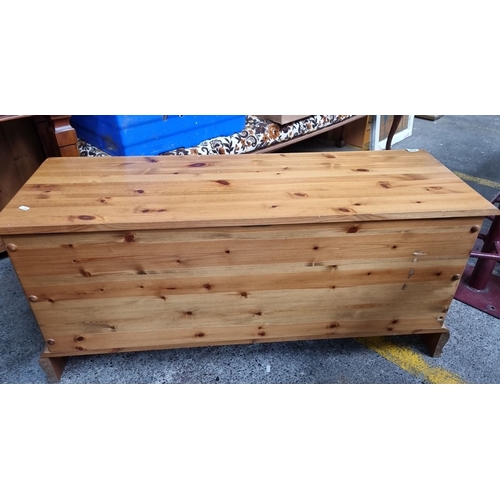 654 - Solid pine blanket chest with hinged lid and carved oval detailing. Measures approximately 40 inches... 