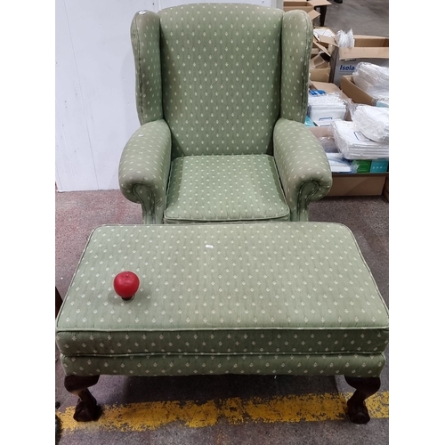 663 - Green upholstered wingback chair with matching ottoman. Features carved wooden cabriole legs and pat... 