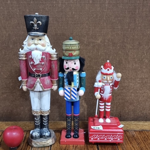 670 - Set of three wooden nutcrackers, varying designs and themes. Includes metal key mechanism.