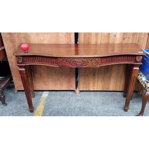 676 - Star lot : A fabulous Mahogany carved console table featuring floral motifs and fluted details. Incl... 