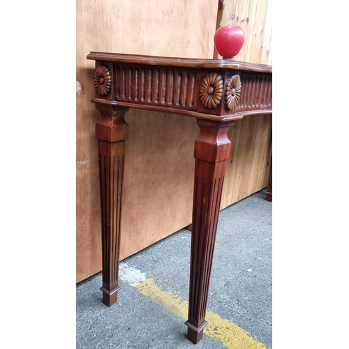 676 - Star lot : A fabulous Mahogany carved console table featuring floral motifs and fluted details. Incl... 