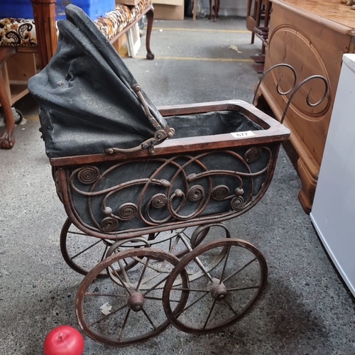 677 - An Antique Wrought iron baby carriage from the Victorian era with an intricately designed metal fram... 