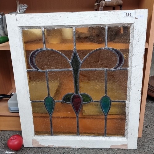 686 - Pair of Victorian stained glass window panes, featuring geometric patterns in vibrant hues of red, g... 