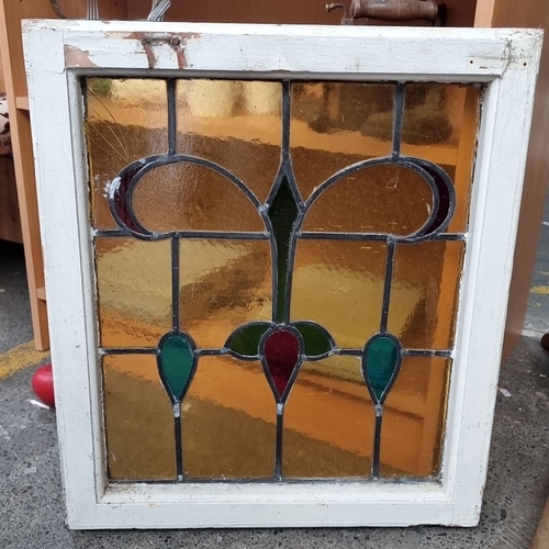 686 - Pair of Victorian stained glass window panes, featuring geometric patterns in vibrant hues of red, g... 