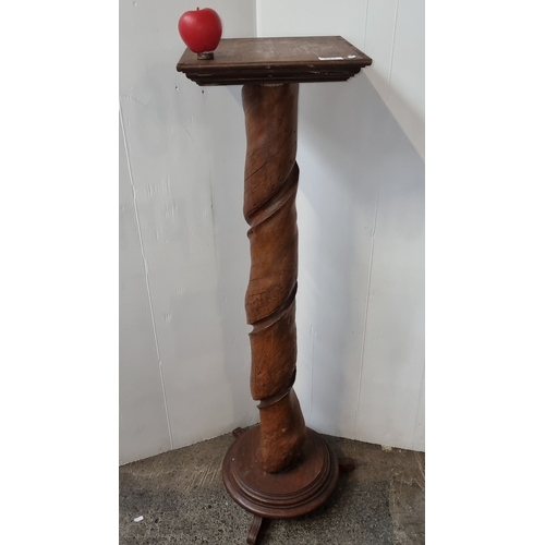 691 - Twisted wood pedestal stand, oak, with a square top and circular base. Period unknown.