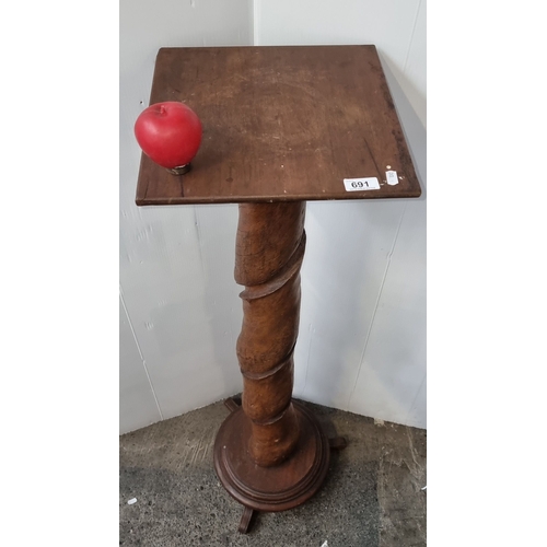 691 - Twisted wood pedestal stand, oak, with a square top and circular base. Period unknown.