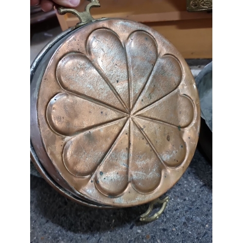 694 - Set of four vintage copper and iron cooking pans feature dual handles and brass accents. Each pan va... 