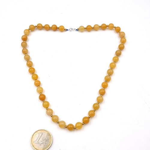 517 - Star Lot : A gorgeous 18 carat gold necklace (marked 750 to clasp) set with butterscotch jade stones... 