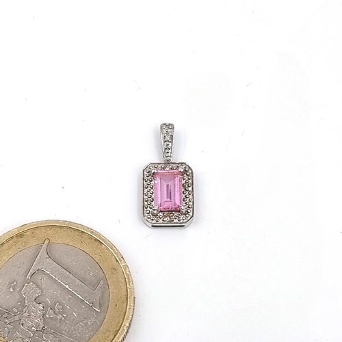 537 - Star Lot : A beautiful nine carat white gold pendant with pink sapphire and diamond mounts. Stamped ... 