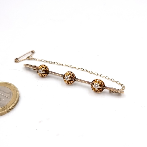 545 - Star Lot : A stunning antique diamond and 14 carat gold bar brooch. Set with three round facet cut d... 