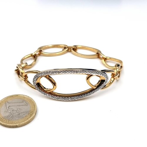 597 - A very nice interlinked gold toned Swarovski crystal bracelet.  Comes in original Swarovski box with... 