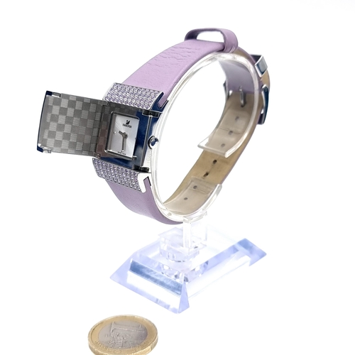 599 - A pre worn most unusual Swarovski Swiss made crystal watch with a lilac leather strap. Comes in orig... 