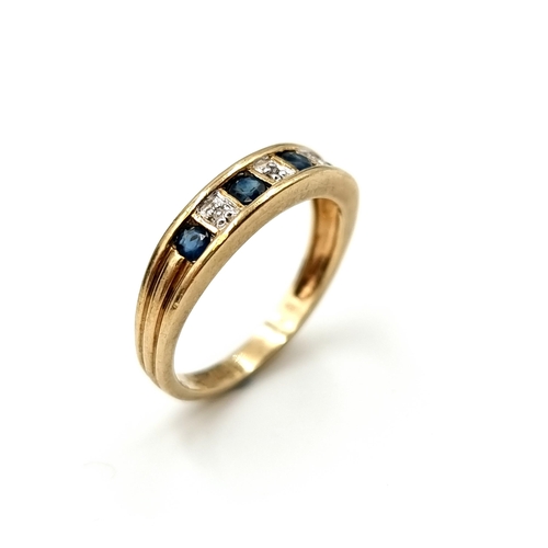 601 - Star Lot : A sapphire and diamond ring set in nine carat gold. Stamped 375. Size N. Weight 2.57 gram... 