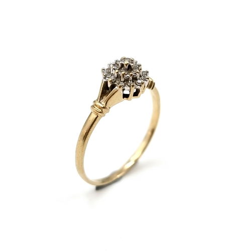 608 - Star Lot : A dazzling diamond cluster ring creating a flower form held within a claw mount on a pier... 