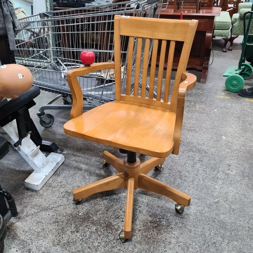 768 - Star Lot : A good quality solid oak captains desk chair with adjustable seat height.