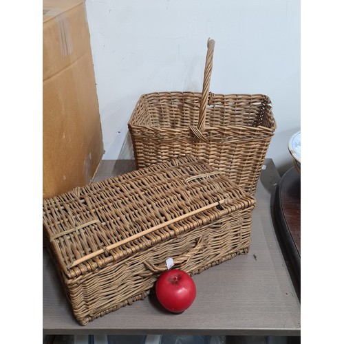 781 - Two vintage wicker baskets including a handled example as well as a neatly sized picnic basket.