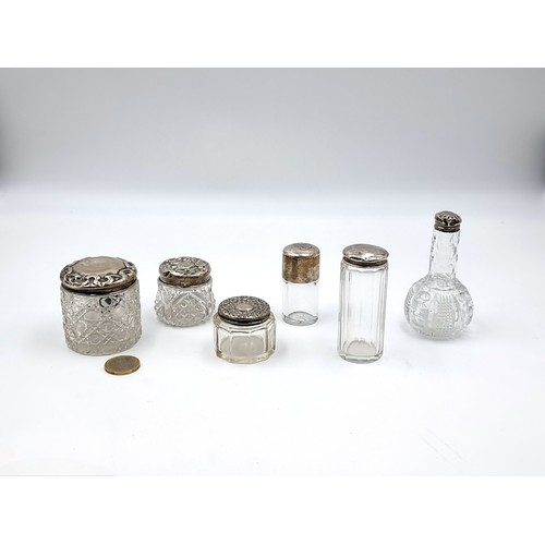 638 - A lot of six antique vintage sterling silver topped perfume bottles and powder jars. Hallmarks for B... 