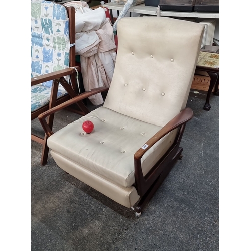 803 - Mid-Century Modern reclining chair with cream upholstery and wooden armrests, featuring a retractabl... 