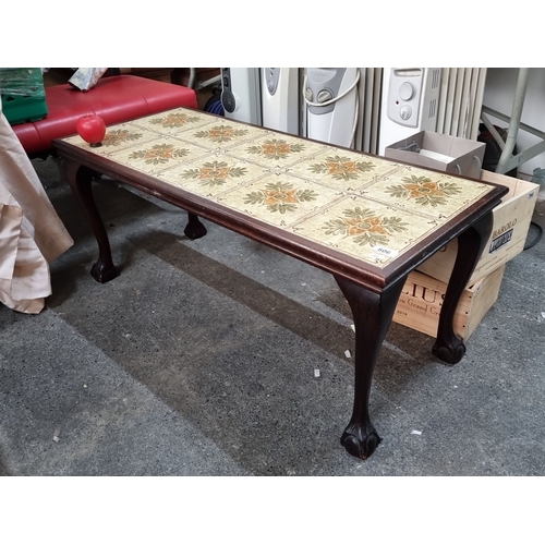 806 - Wood-tile coffee table with floral patterned tiles set in a dark wood frame, featuring cabriole legs... 