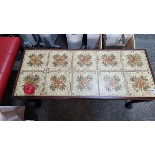 806 - Wood-tile coffee table with floral patterned tiles set in a dark wood frame, featuring cabriole legs... 