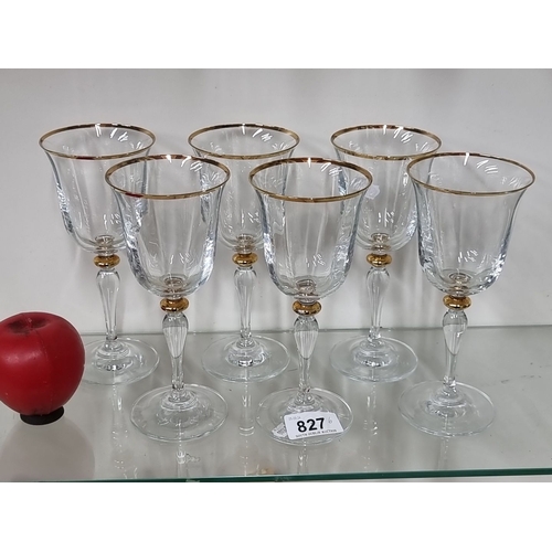 827 - Set of six crystal wine glasses featuring intricate etched design, gold rim, and gold accent on the ... 