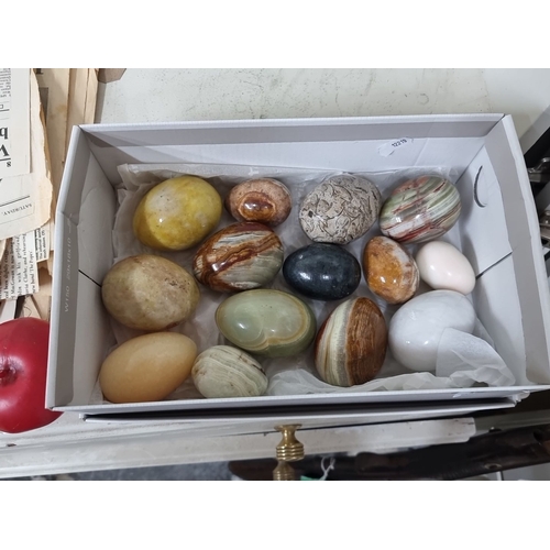 829 - Collection of twelve polished decorative stone eggs in a variety of colors and patterns. Stones incl... 