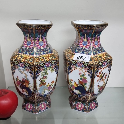 857 - Pair of Chinese ceramic hexagonal vases feature intricate hand-painted floral and bird motifs, with ... 