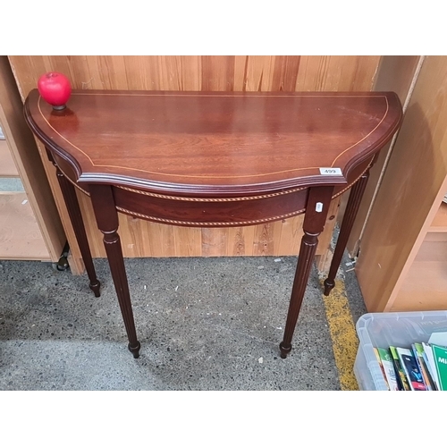 1385 - A mahogany demi-lune console table with elegant string inlay and tapered legs. Lovely clean conditio... 