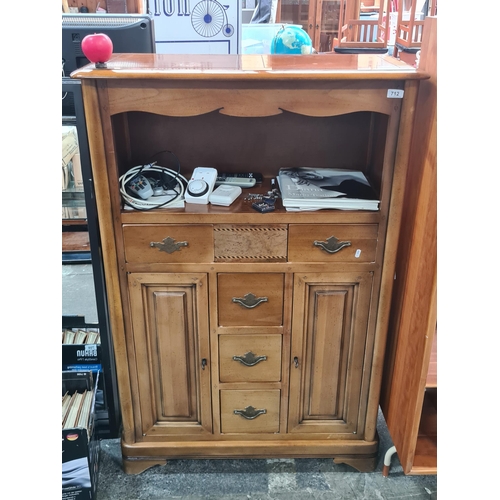 1390 - A tall mid 1930s cabinet  boasting cupboards to either side and five neatly sized pull out drawers w... 