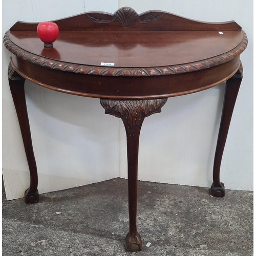 1391 - A nice example of an antique demi lune table featuring a gallery back, gadrooned edge with cabriole ... 