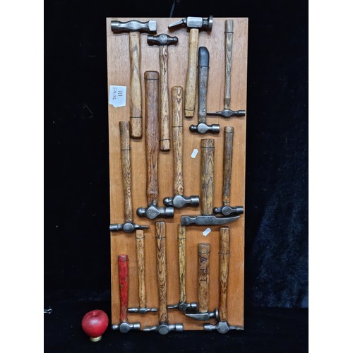 111 - A beautiful collection of 16 antique hammers mounted on a wooden board for display purposes. Most ha... 