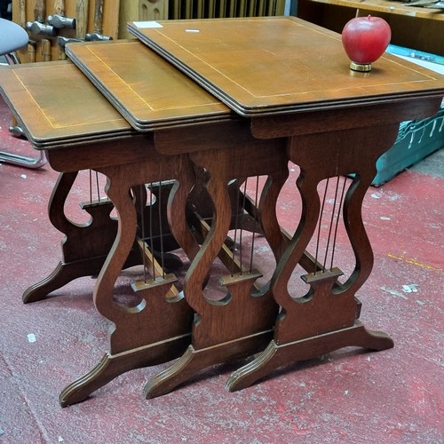 325 - A gorgeous set of three mahogany nesting tables standing on elegant harp shape supports, making them... 