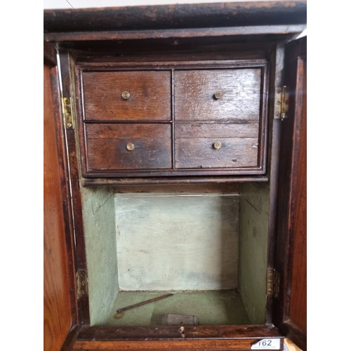 162 - A fantastic antique hand carved mahogany medicine cabinet featuring double doors to front, brass han... 