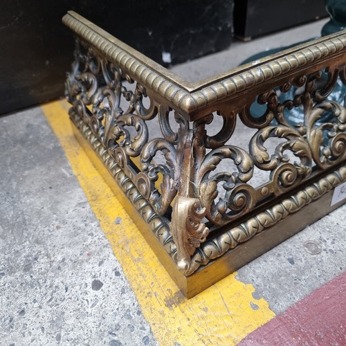 392 - Star Lot : A stunning pierced brass fire fender with intricate agapanthus leaf scrollwork throughout... 