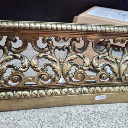 392 - Star Lot : A stunning pierced brass fire fender with intricate agapanthus leaf scrollwork throughout... 