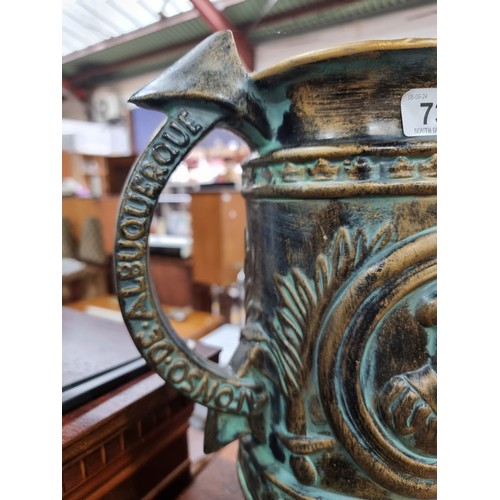 739 - A large ceramic pitcher in a copper finish with nautical theme.