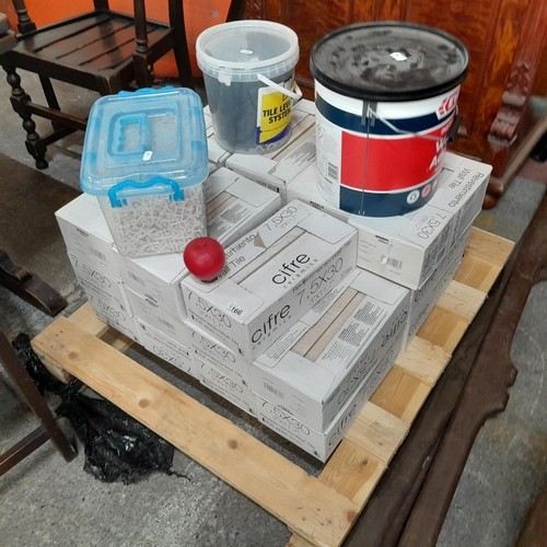 757 - A large palette containing twenty two boxes of ceramic marble effect wall tiles. Along with a bucket... 