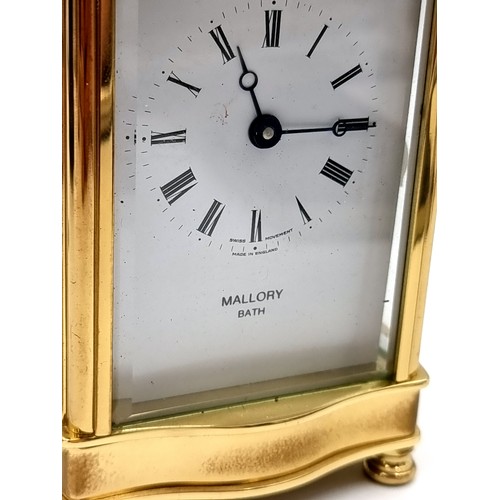 18 - A heavy Mallory Bath brass carriage clock with roman numeral dial. Comes with original key.