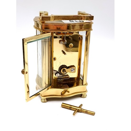 18 - A heavy Mallory Bath brass carriage clock with roman numeral dial. Comes with original key.