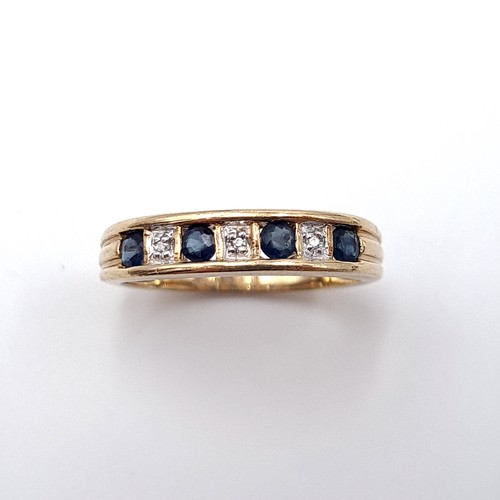 601 - Star Lot : A sapphire and diamond ring set in nine carat gold. Stamped 375. Size N. Weight 2.57 gram... 