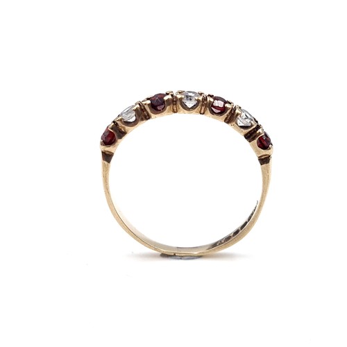 606 - A very pretty garnet and gemstone ring set in nine carat gold. Size P1/2. Weight 1.60 grams. Boxed.