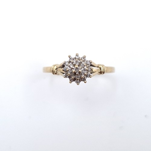 608 - Star Lot : A dazzling diamond cluster ring creating a flower form held within a claw mount on a pier... 