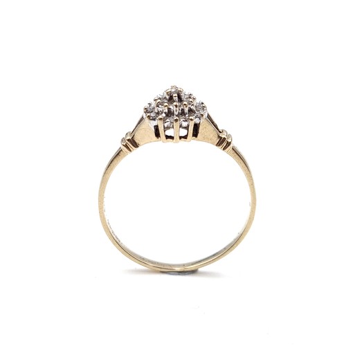 608 - Star Lot : A dazzling diamond cluster ring creating a flower form held within a claw mount on a pier... 