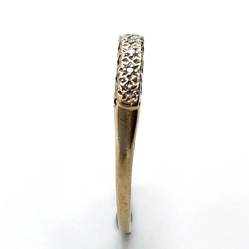 609 - An eye catching diamond ring set in nine carat gold. Stamped 375. Size O. Weight 1.16 grams. Boxed.