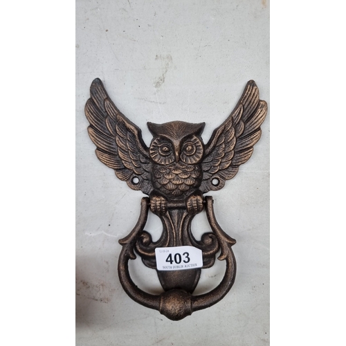 403 - Bronze owl-shaped door knocker, intricately detailed with spread wings. Cast bronze material.