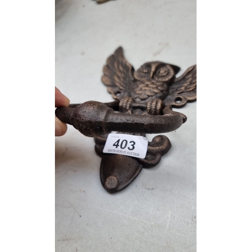 403 - Bronze owl-shaped door knocker, intricately detailed with spread wings. Cast bronze material.