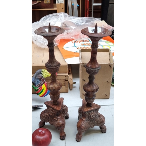 405 - Pair of tall antique style wooden candlesticks with intricate carvings and tripod lion feet, from th... 