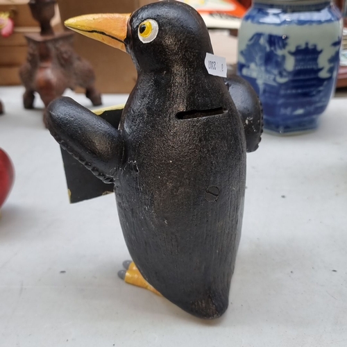 407 - Hand-painted heavy cast metal  penguin holding a 